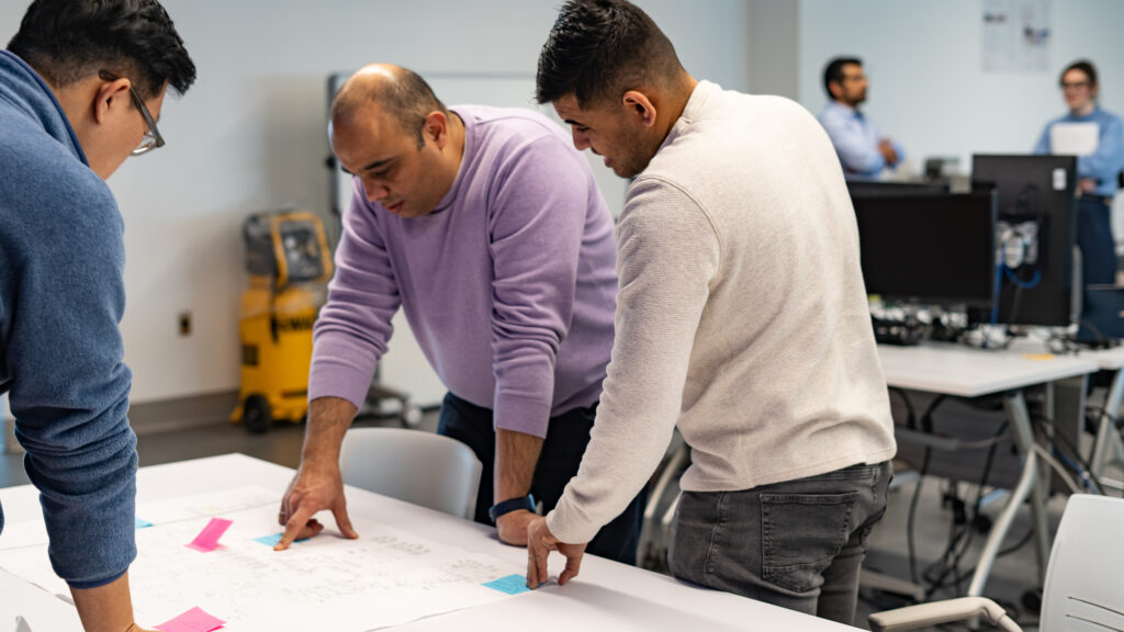 Sherif Abdou and other researchers collaborating in a lab at Mohawk College