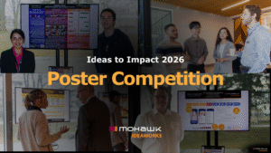 Collage of photographs showing researchers and attendees presenting and viewing research posters at the Ideas to Impact 2026 conference. Top left: woman in dark blazer smiling next to blue and burgundy research poster on display monitor. Top center and right: group of five attendees standing and observing poster presentations, with wooden ceiling visible. Bottom left: woman in beige cardigan gesturing while explaining yellow and black research poster to attendees. Bottom center: man in glasses viewing poster on display monitor. Bottom right: man viewing blue and orange research poster on display monitor. Large white text overlay reads "Ideas to Impact 2026" with gold text below reading "Poster Competition." Mohawk IdeaWorks logo in orange and black appears in bottom center and corner.